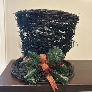 Decorative snowman hat measuring 10 inches tall and 12 inches wide.